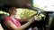 Young beautiful bald woman in sunglasses sitting at the wheel of a car on a summer day. car trip