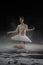 Young beautiful ballerina dancing in flour in the studio