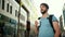 Young beautiful bearded man drinking coffee on the streets of city