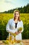 A young beautiful biologist or agronomist examines the quality of rapeseed oil on a rape field. Agribusiness concept