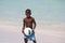 Young beautiful black boy  in blue shorts  playing football on the sunny caribbean beach just after swimming .Bavaro beach,Punta