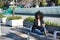 Young, beautiful, black woman with afro hair, with jacket and sunglasses sitting on a bench, looking at infinity, relaxed,