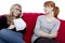 Young beautiful blond and red haired girls open a letter on red