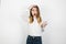 Young beautiful blond woman looking lost standing on isolated white background touching her head , body language concept