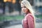 Young beautiful blond woman portrait posing in city street on sunset