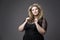 Young beautiful blonde plus size model in black dres, xxl woman portrait on gray studio background