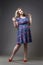 Young beautiful blonde plus size model in dress and shoes, xxl woman on gray studio background