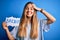 Young beautiful blonde woman with blue eyes holding banner with brexit message stressed with hand on head, shocked with shame and