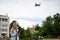 Young beautiful blonde woman piloting a drone holding a remote control