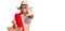 Young beautiful blonde woman wearing bikini and hat holding summer wicker handbag with open hand doing stop sign with serious and