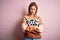 Young beautiful blonde woman wearing fashion animal print sweater over pink background skeptic and nervous, disapproving