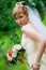 Young beautiful bride with flowers outdoor