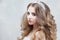 Young beautiful bride with luxurious curls. Wedding hairstyle with tiara.