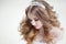 Young beautiful bride with luxurious curls. Wedding hairstyle with tiara.