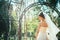 Young beautiful bride standing in a park gazebo.