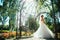 Young beautiful bride standing in a park gazebo.