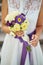 young beautiful bride in white dress holding wedding bouquet, bouquet of bride from rose purple Memory Lane, violet eustoma, eucal