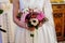 young beautiful bride in white dress holding wedding bouquet, bouquet of bride from rose purple Memory Lane, violet eustoma, eucal