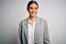 Young beautiful brunette businesswoman wearing jacket standing over white background with a happy and cool smile on face