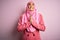 Young beautiful brunette businesswoman wearing pink muslim hijab and business jacket begging and praying with hands together with