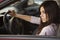 Young beautiful brunette caucasian woman driving a red car. sum