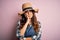 Young beautiful brunette farmer woman wearing apron and hat over pink background thinking looking tired and bored with depression