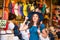 Young and beautiful brunette girl in dress and hat walking outdoor at the market. Nice, France. Summer vacation