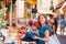 Young and beautiful brunette girl in dress and hat walking outdoor at the market. Nice, France. Summer vacation