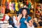 Young and beautiful brunette girl in dress and hat walking outdoor at the market. Nice, France. Summer vacation