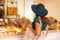 Young and beautiful brunette girl in dress and hat walking outdoor at the market. Nice, France. Summer vacation