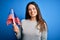 Young beautiful brunette patriotic woman holding american flag celebrating 4th of july with a happy face standing and smiling with