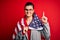 Young beautiful brunette patriotic woman wearing usa flag celebrating independence day surprised with an idea or question pointing