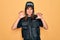 Young beautiful brunette policewoman wearing police uniform bulletproof and cap smiling funny doing claw gesture as cat,