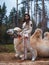 Young beautiful brunette in a rider costume next to a big white camel