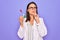 Young beautiful brunette scientist woman wearing coat and glasses holding test tube serious face thinking about question with hand