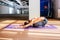 Young beautiful brunette woman making stretching exercises in a light studio. Well being, wellness concept. Yoga balasana pose