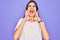 Young beautiful brunette woman wearing casual white t-shirt over purple background Shouting angry out loud with hands over mouth