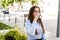 Young beautiful businesswoman drinks coffee to go