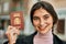 Young beautiful businesswoman smiling happy holding spainish passport at the city