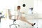 Young beautiful businesswoman stretching in office.