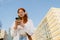 Young beautiful calm redhead girl in headphones holding her phone