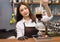 Young beautiful caucasian barista prepare coffee Syphon Stir th