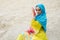 Young beautiful Caucasian woman posing in arabian costume in desert