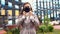 Young beautiful caucasian woman puts a black face mask over her face to protect herself during a pandemic