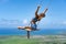 Young beautiful caucasian woman on the rope swing with sea and sky background. Concept of dream and happiness