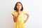 Young beautiful child girl wearing yellow floral dress standing over isolated white background Thinking concentrated about doubt