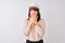 Young beautiful Chinese architect woman wearing helmet over isolated white background shocked covering mouth with hands for