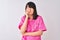 Young beautiful Chinese nurse woman wearing stethoscope over isolated white background looking stressed and nervous with hands on