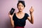 Young beautiful chinese woman holding broken smartphone showing craked screen annoyed and frustrated shouting with anger, crazy