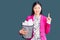 Young beautiful chinese woman holding paper bin full of crumpled papers surprised with an idea or question pointing finger with